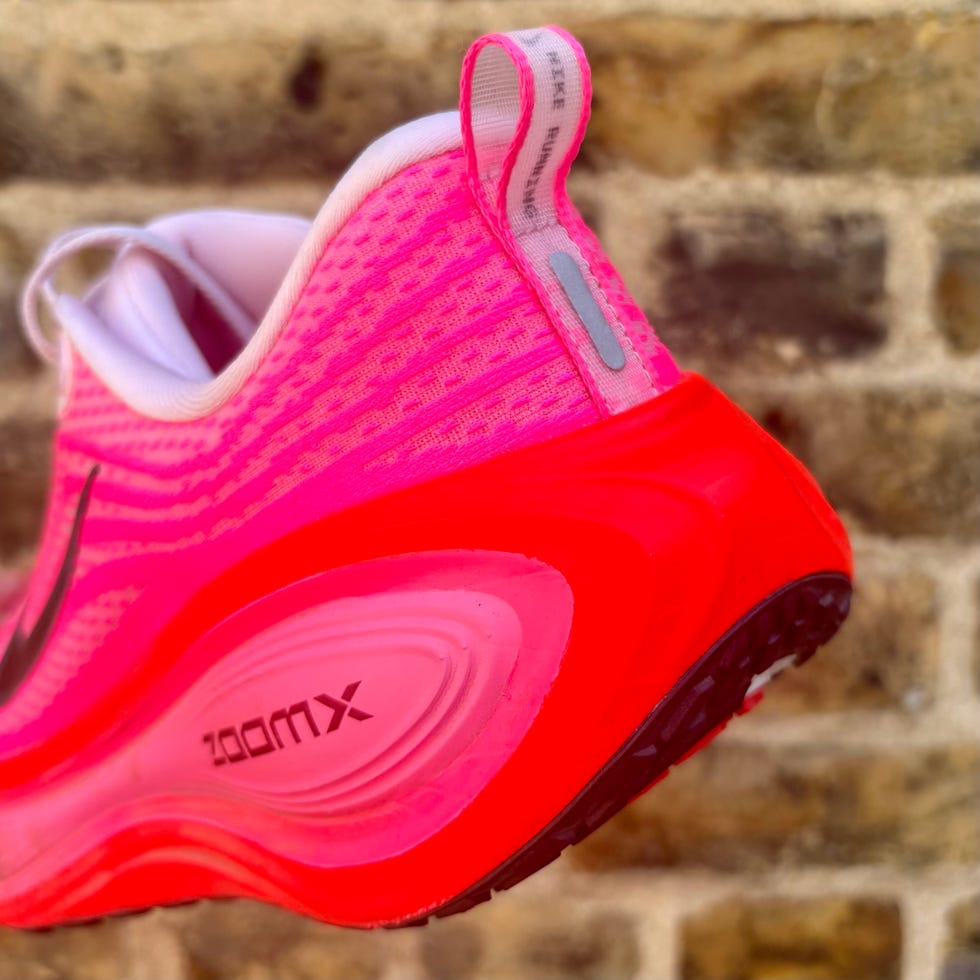 the heel of a running shoe against the backdrop of a brick wall