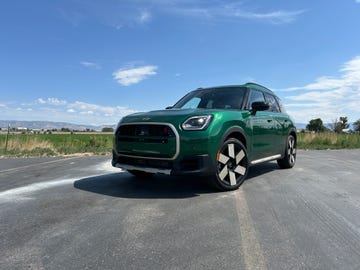 a green car parked on a road