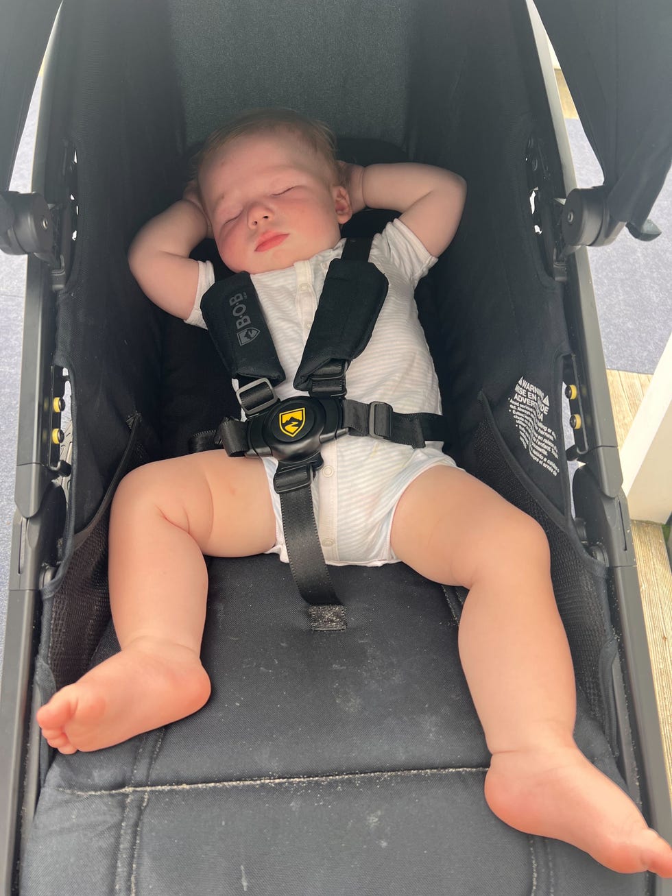 a bob wayfinder jogging stroller at the beach with a baby asleep and buckled in, part of a good housekeeping review of the best jogging strollers