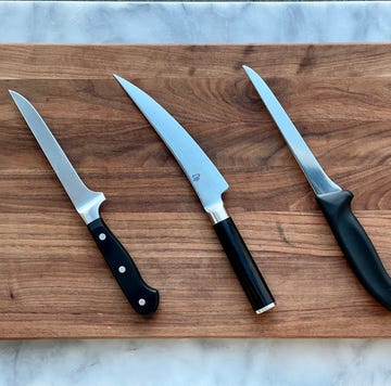 a group of knives on a cutting board a group of knives on a cutting board