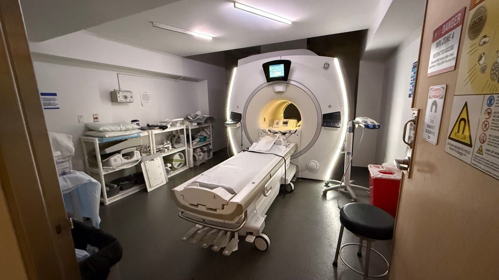 mri room with scanning machine and medical equipment