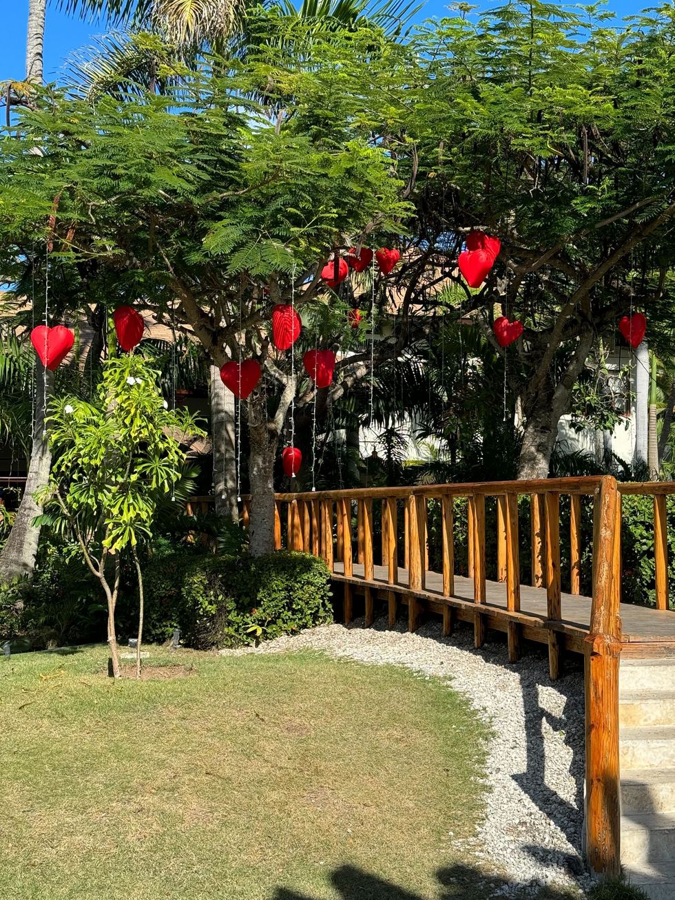 a wooden fence with red lanterns from it