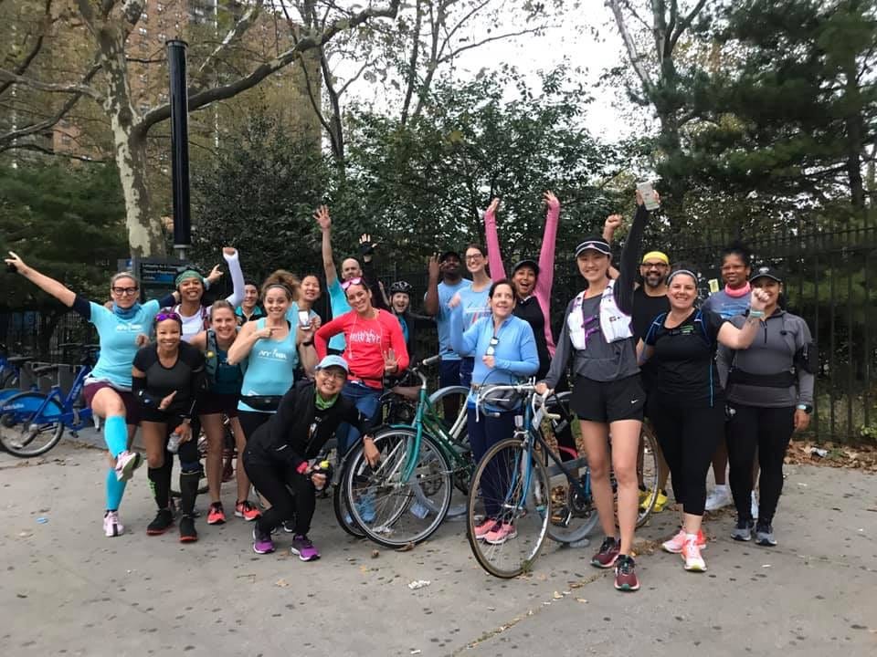 group of women celebrating outdoors some with bicycles