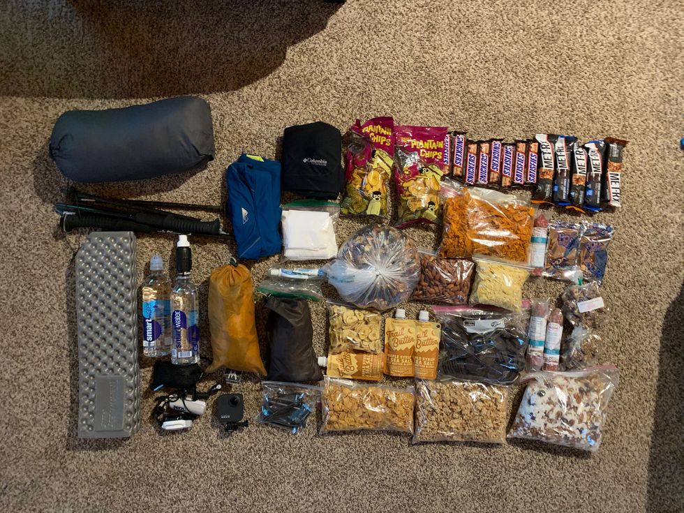 all of joe mcconaughy’s gear and food that he carried on the run laid out on the floor