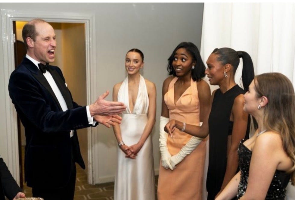 a man in a suit and a woman in a dress with other people