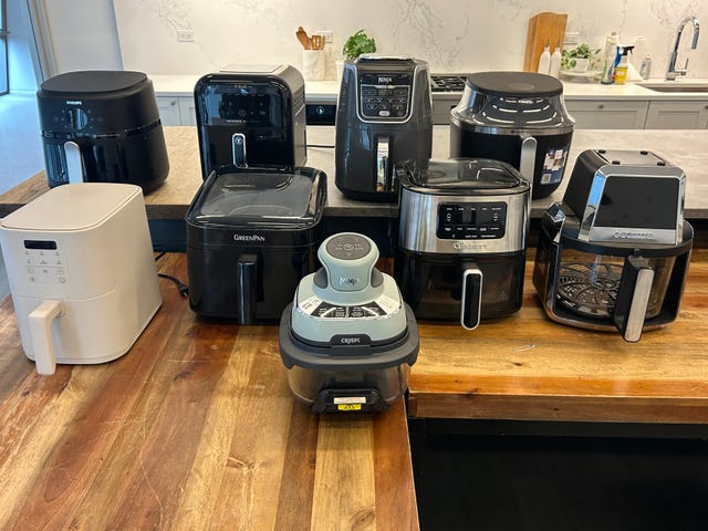 various air fryers displayed on a kitchen countertop