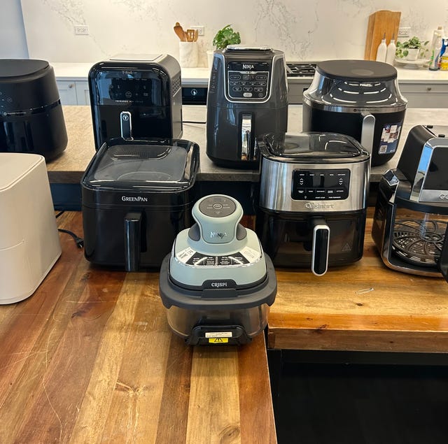 various air fryers displayed on a kitchen countertop various air fryers displayed on a kitchen countertop