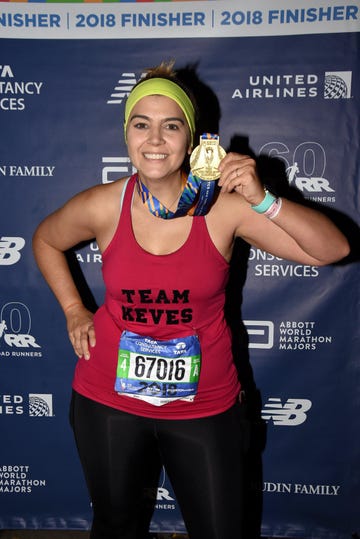 runner celebrating completion of a marathon with a medal