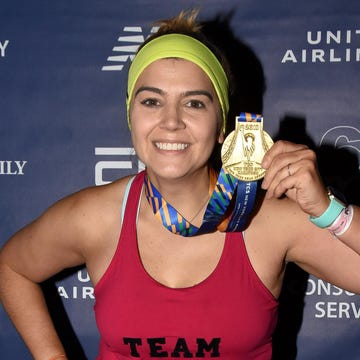 runner celebrating completion of a marathon with a medal runner celebrating completion of a marathon with a medal