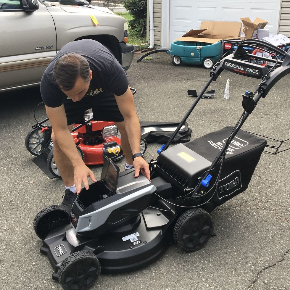 a good housekeeping expert assembles a lawn mower to determine ease of use