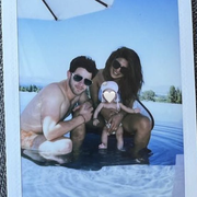 polaroid showing priyanka and nick holding their baby by a pool