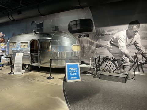 airstream heritage center exhibit showing the trailer that was towed by a bicycle