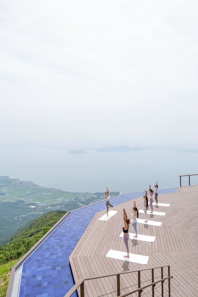 a group of people on a wooden platform overlooking a body of water