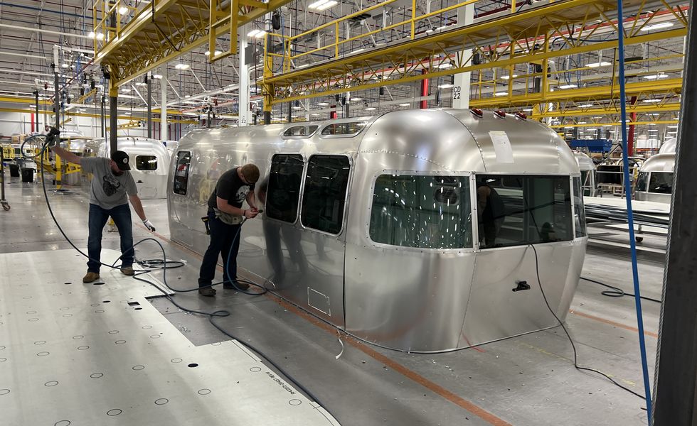 two workers assembling a brand new airstream trailer