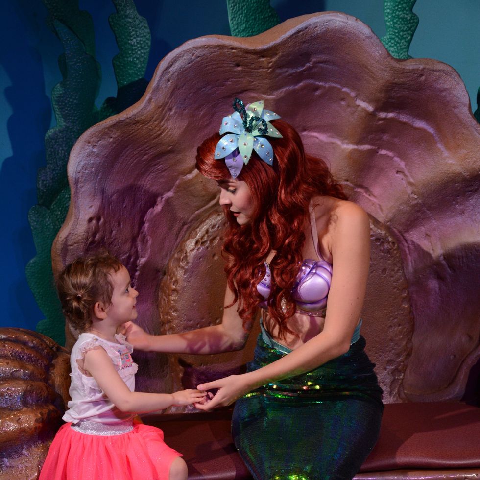 a child meeting ariel the little mermaid at walt disney world magic kingdom