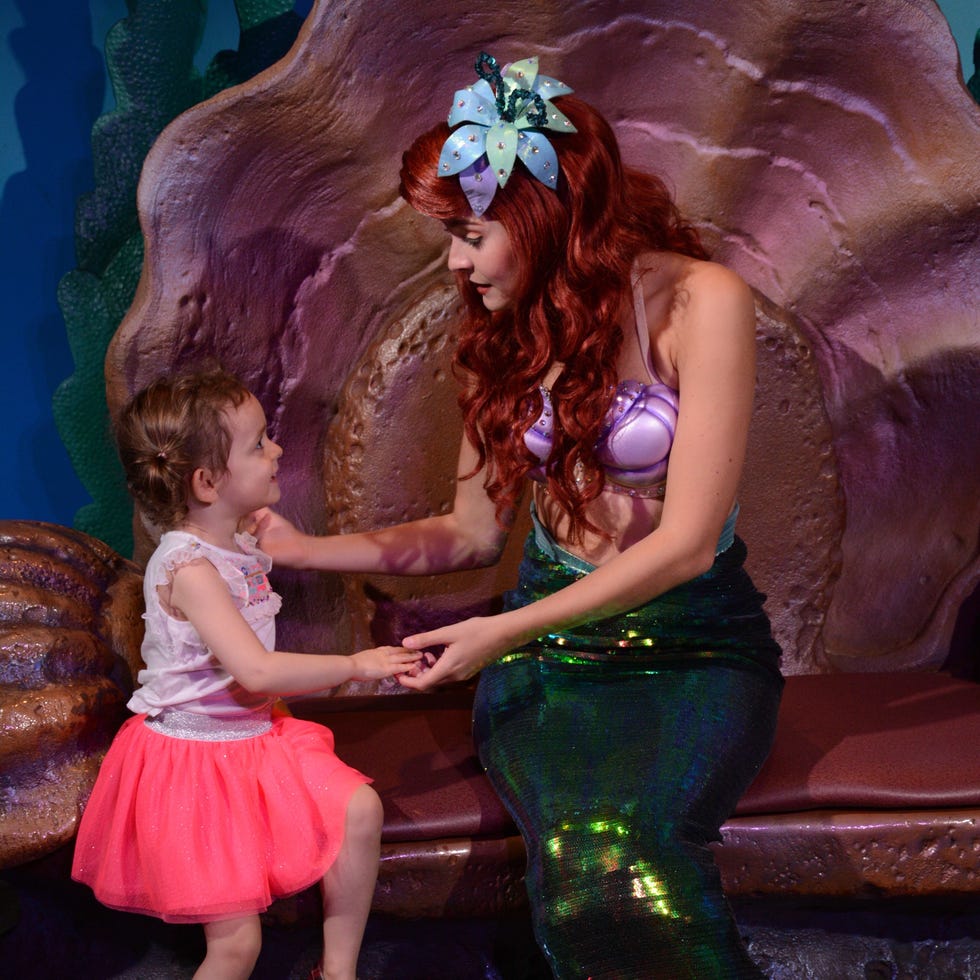 a child meeting ariel the little mermaid at walt disney world magic kingdom a child meeting ariel the little mermaid at walt disney world magic kingdom