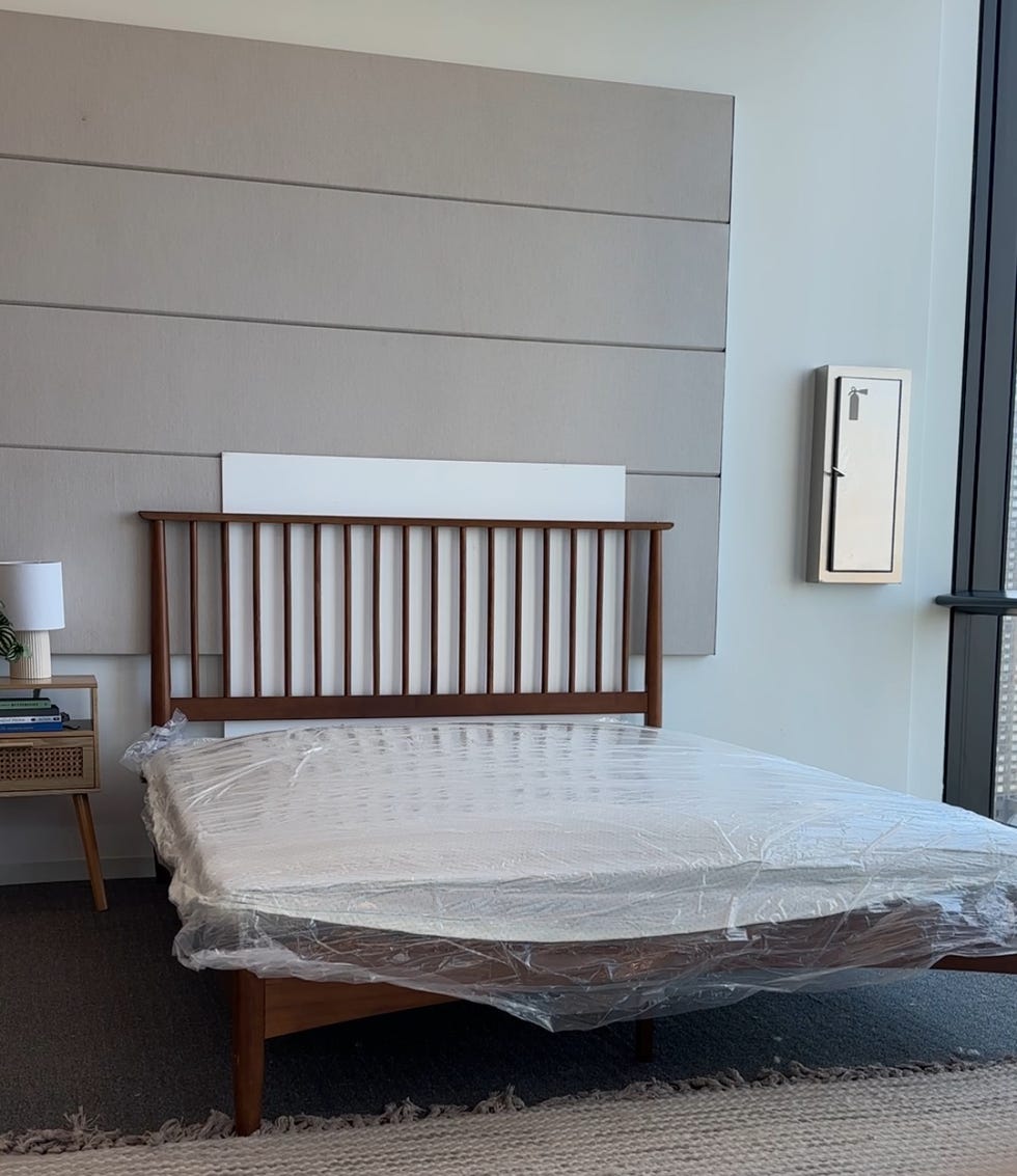a compressed mattress in a bag flat on a queen size bed frame