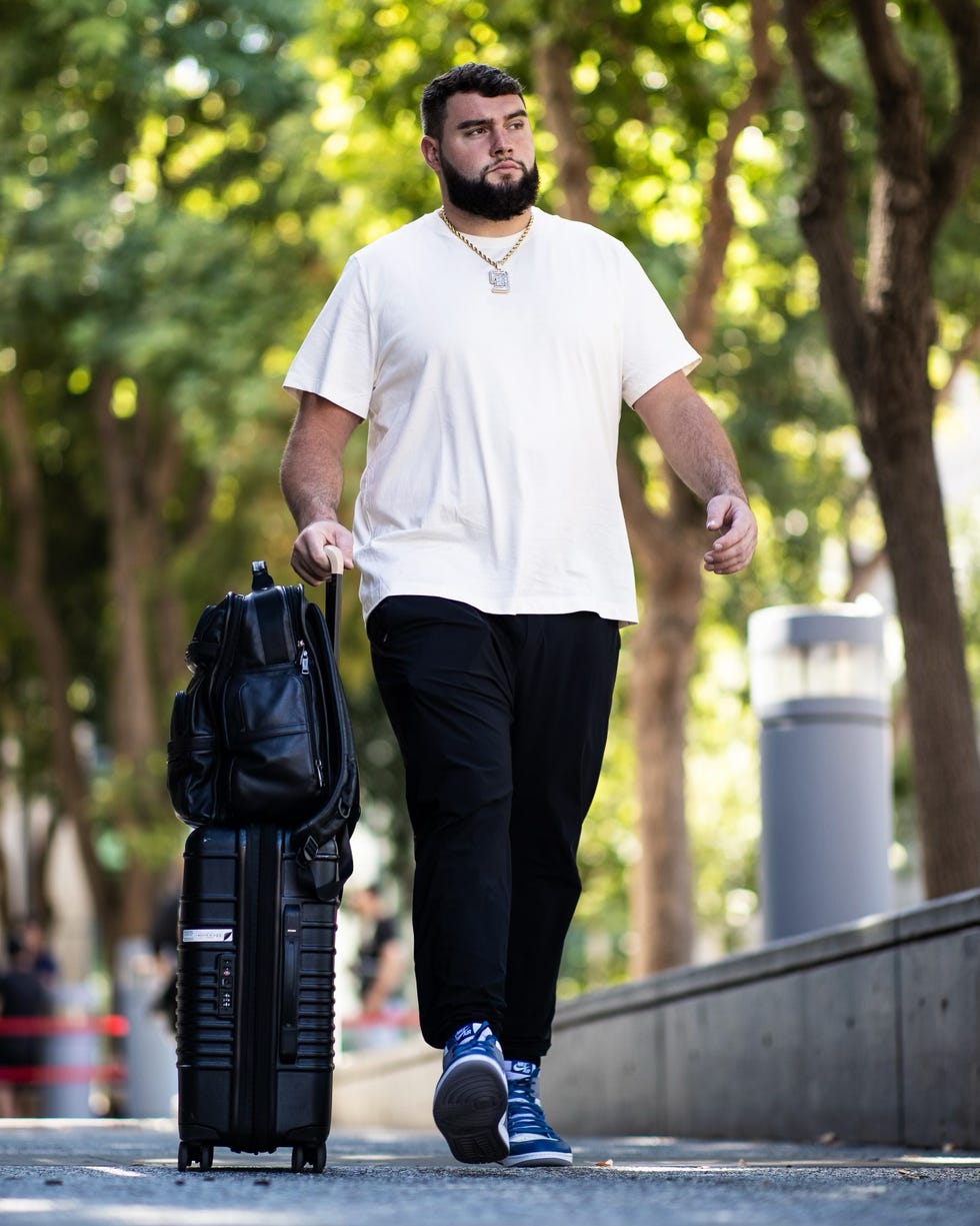 a man walking with a backpack