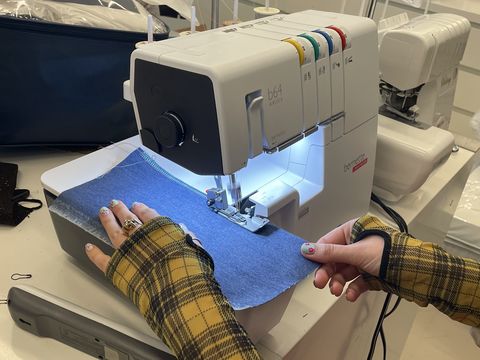 a good housekeeping institute analyst testing a serger in lab as part of serger testing to find the best sergers