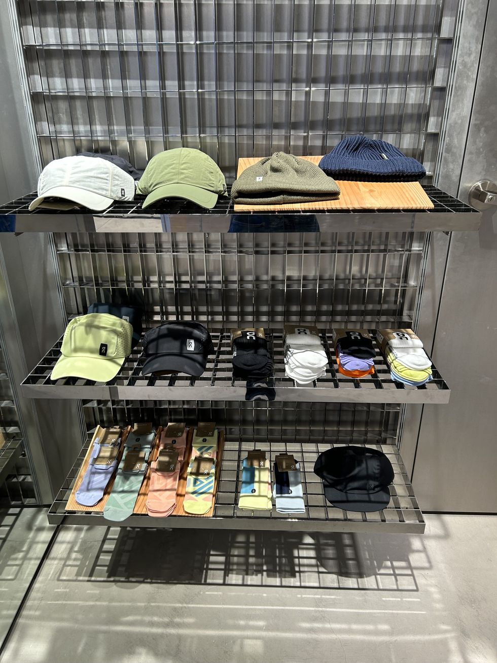 a shelf with various bags and hats
