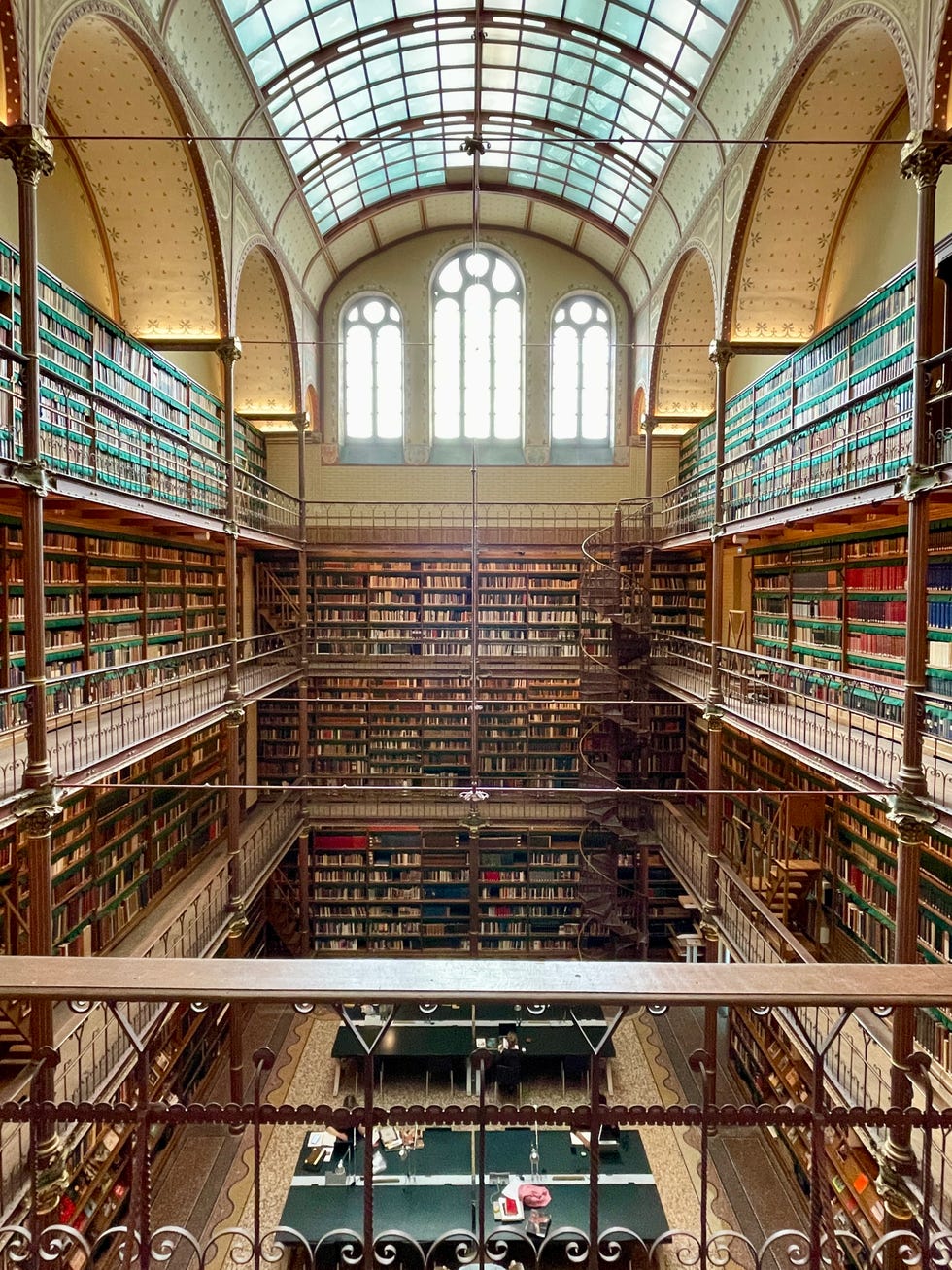 historic library interior with multiple levels of bookshelves