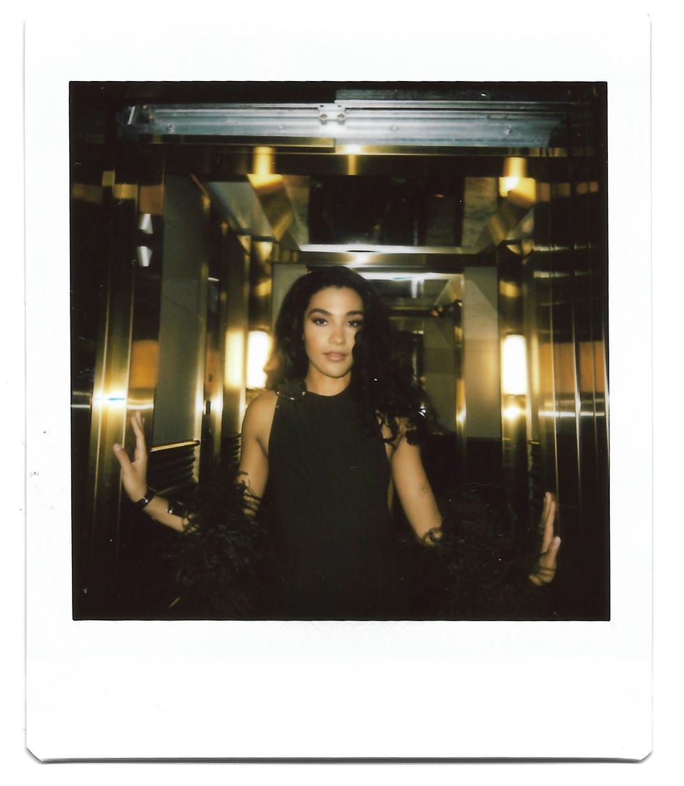 adult woman standing in a reflective elevator