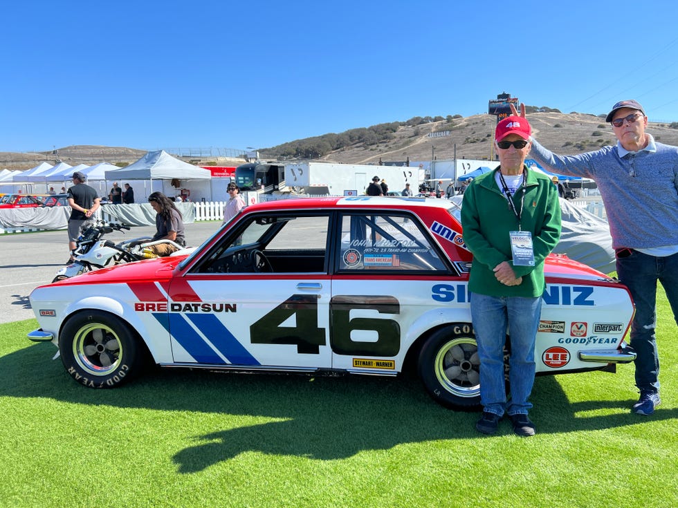 john morton gets bunny ears from a friend next to a datsun