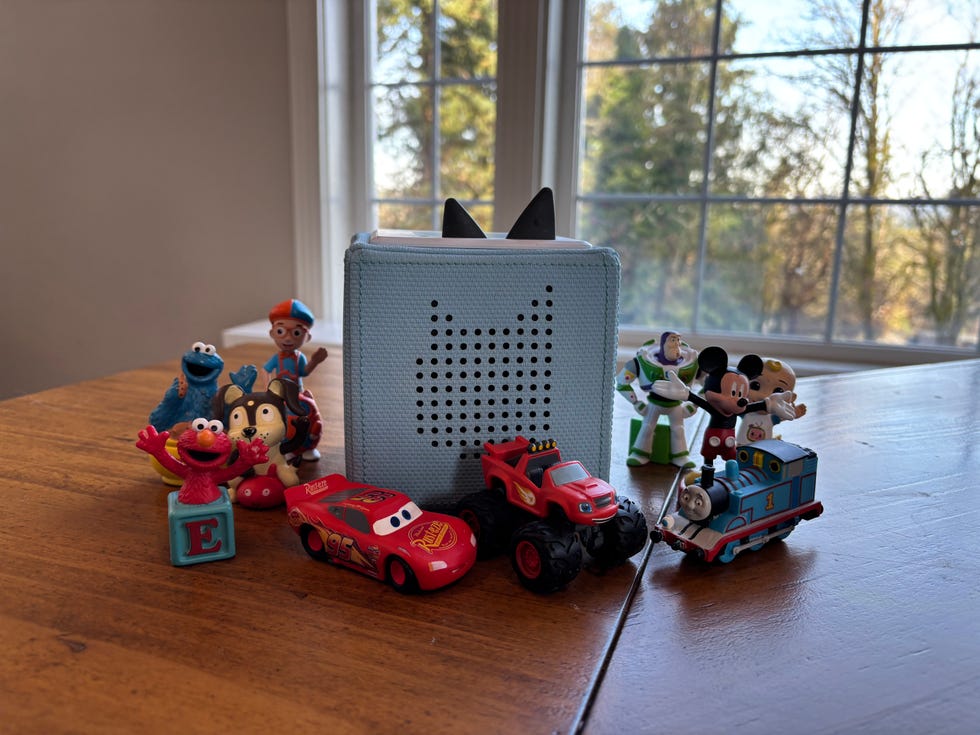 a collection of childrens toys arranged around a speaker
