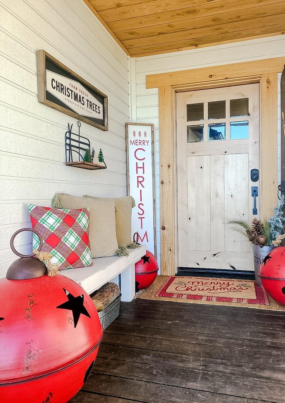 christmas porch with bench and large ornaments