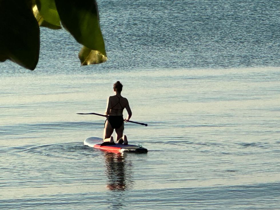 a man paddle boarding on the water