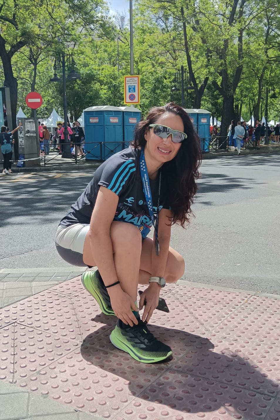 a person sitting on a sidewalk a person sitting on a sidewalk