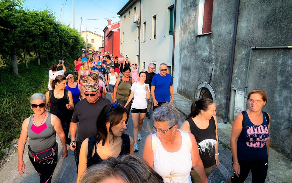 a group of people walking down a street