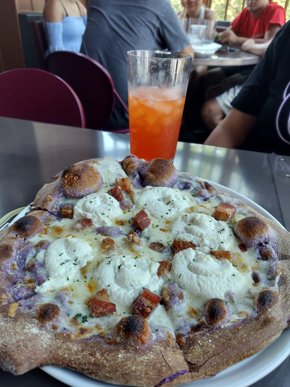 a pizza with a purple ube crust