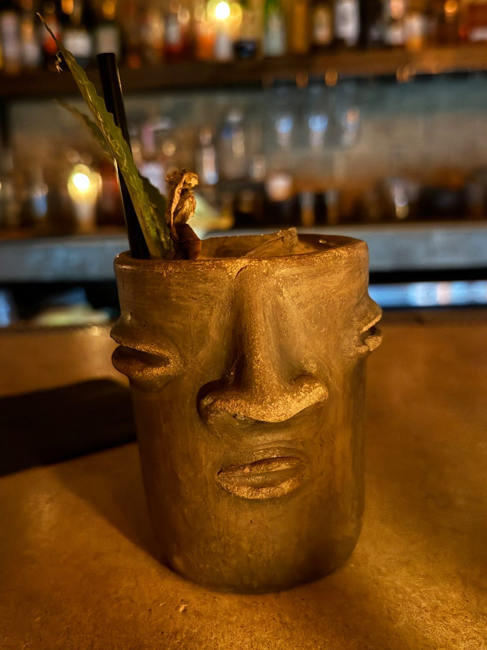 a clay vase with a plant in it