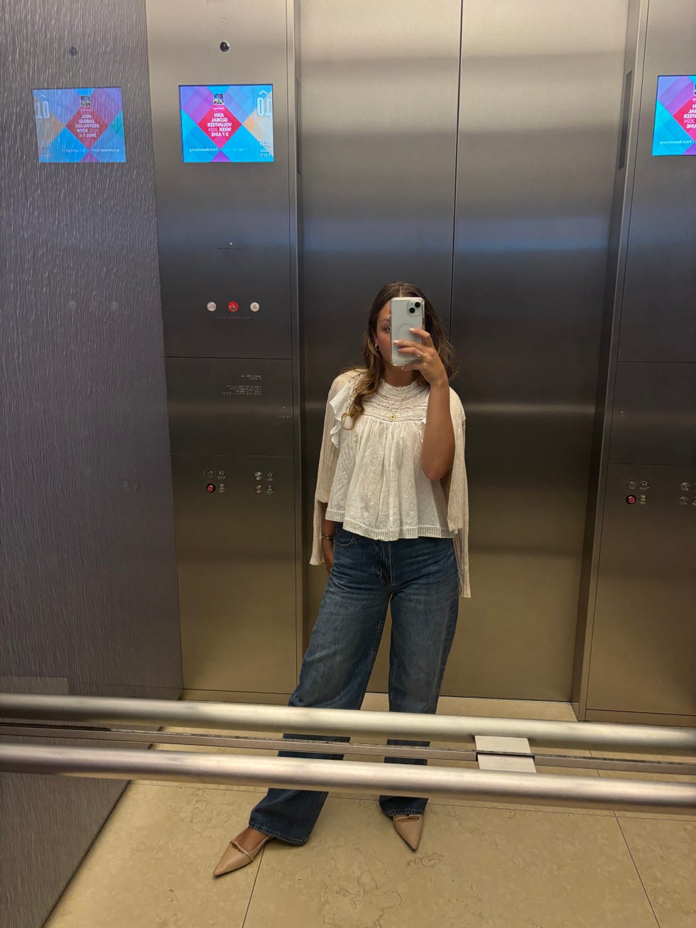 a tester wearing aritzia denim forum 90s wide leg jeans in an elevator mirror selfie, good housekeeping's testing for the best jeans for women
