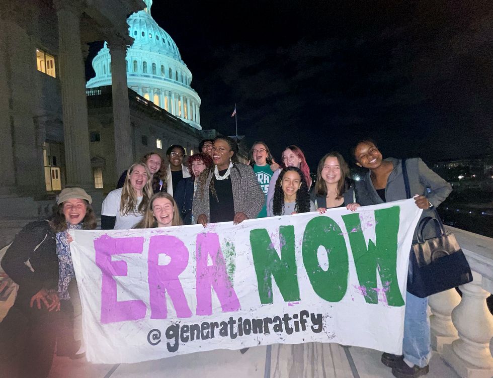 cori bush standing with generation ratify organizers holding a banner that says era now