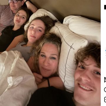 a group of people lying in bed