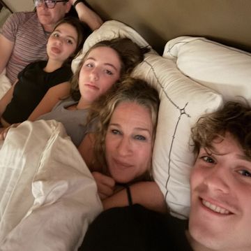 a group of people lying in bed