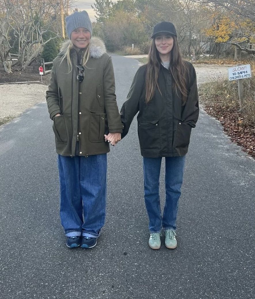 a man and woman standing on a road