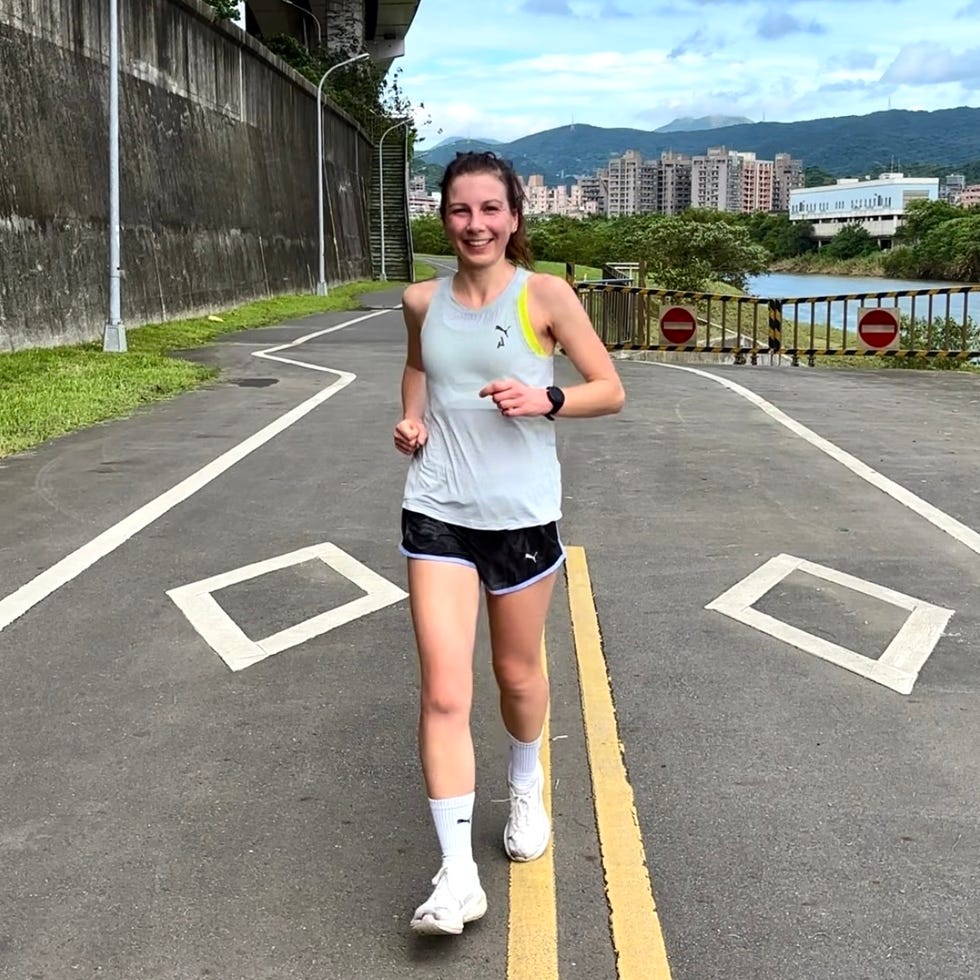 person jogging along a pathway near a river
