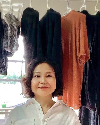 a woman standing in a clothing store