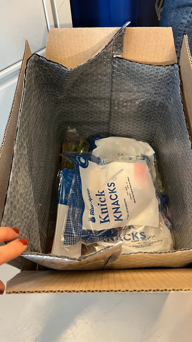 blue apron opened box with ingredients