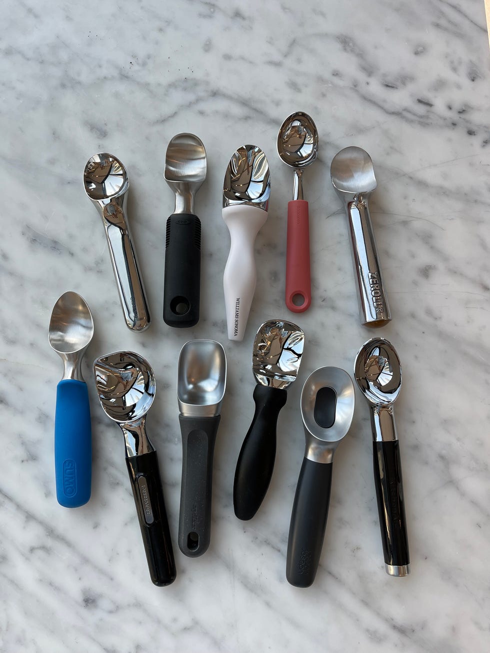 a collection of ice cream scoops arranged on a marble surface
