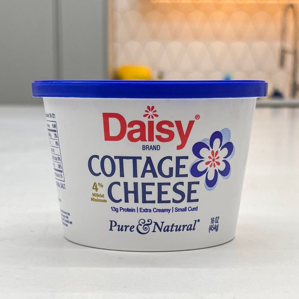 container of daisy brand cottage cheese featuring a blue lid and descriptive labeling