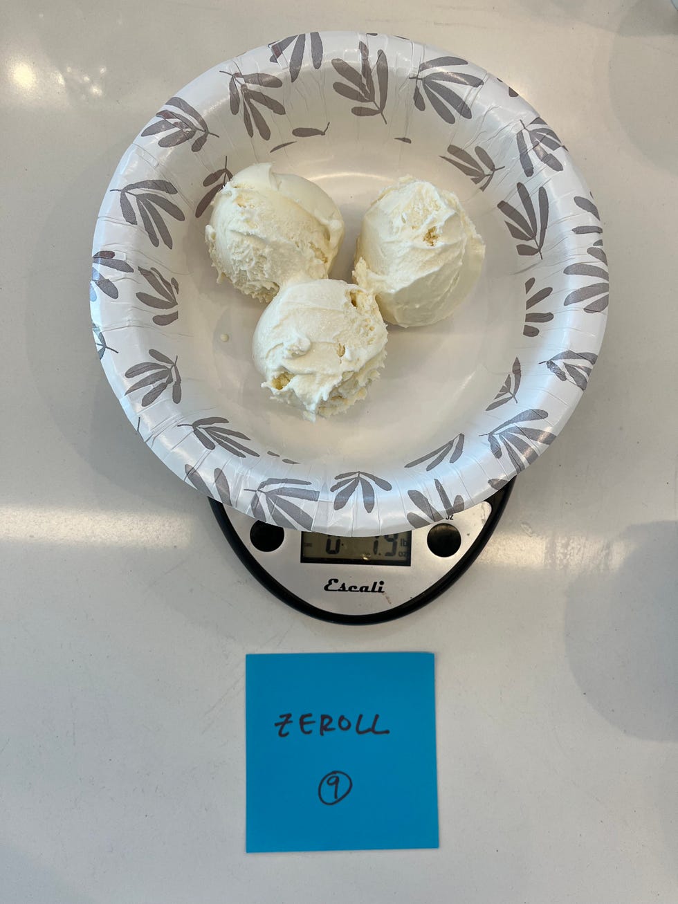 three scoops of vanilla ice cream in a paper bowl