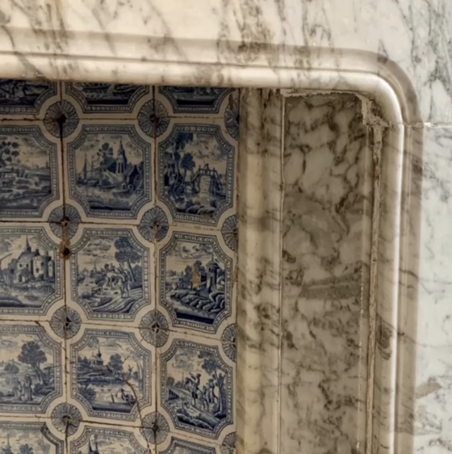 carrara marble and delft tile fireplace