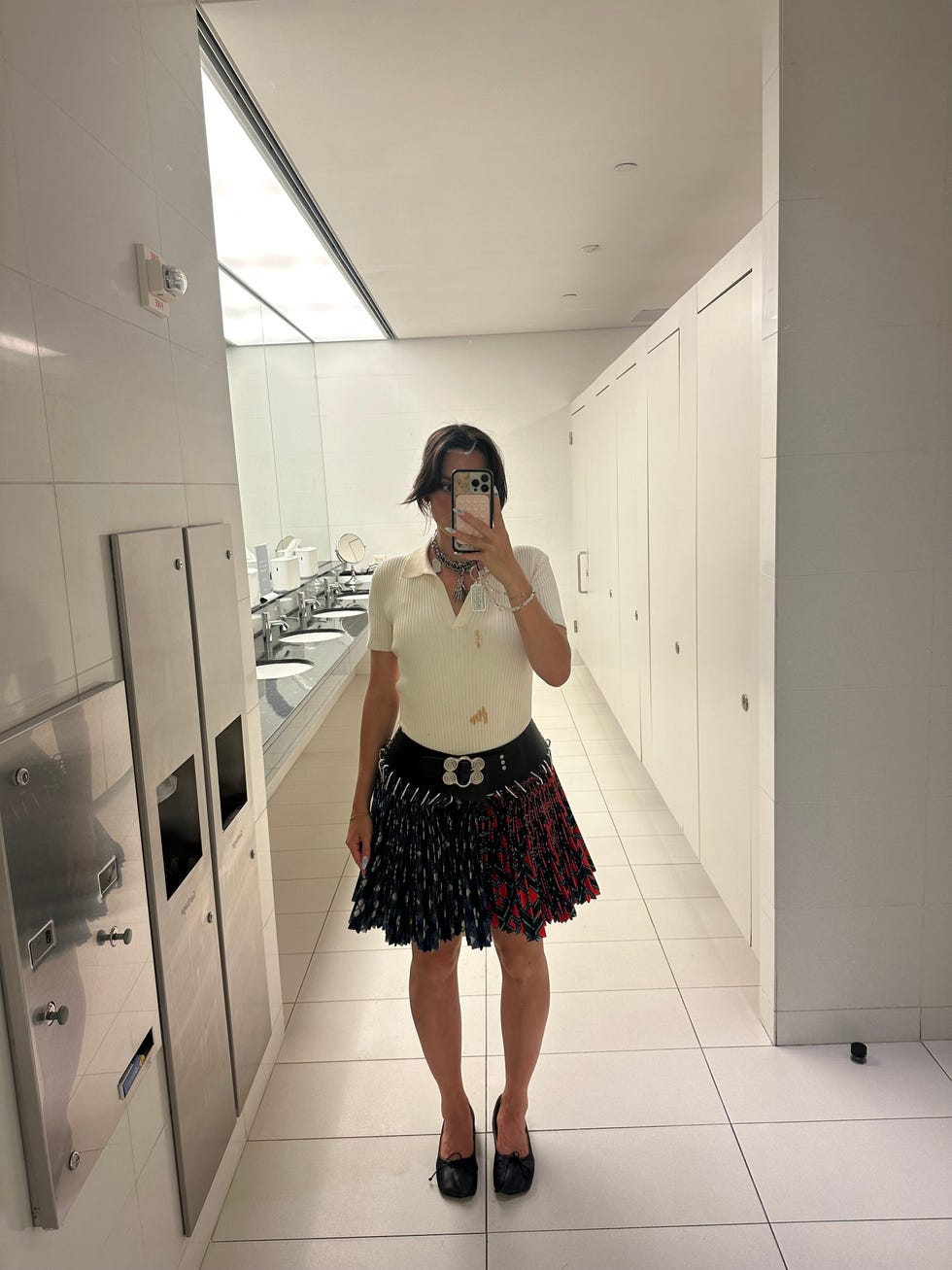 a woman taking a selfie in a bathroom