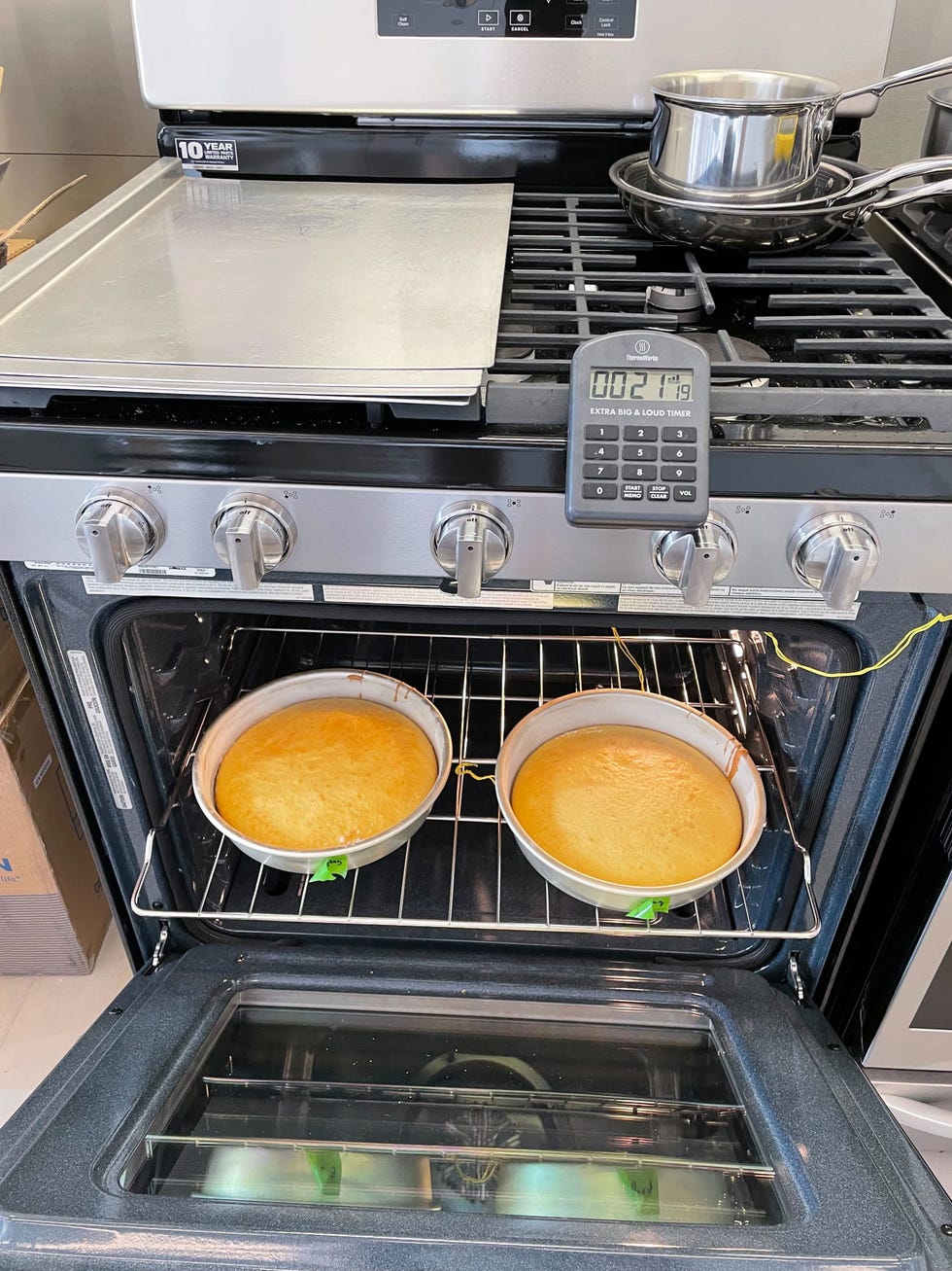 two cakes baking in an oven