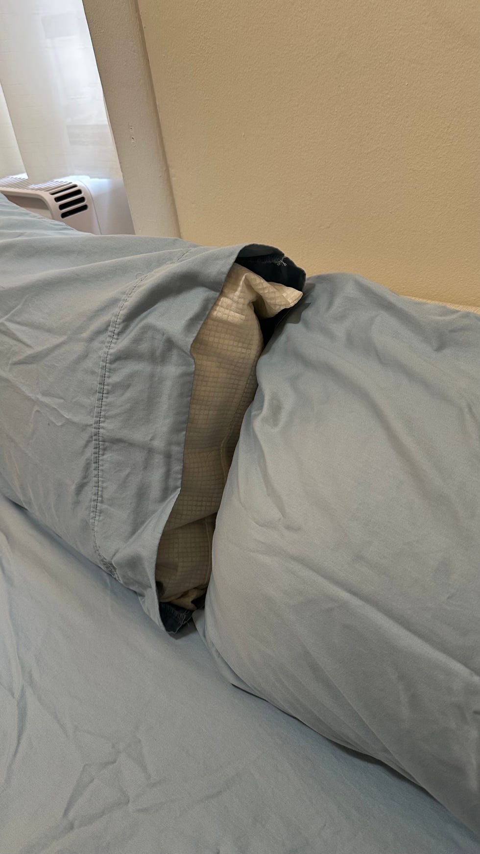 a blue califorina design den sheets with an open pillowcase on a bed