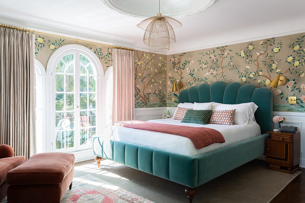 bedroom with real upholstered headboard and floral wallpaper